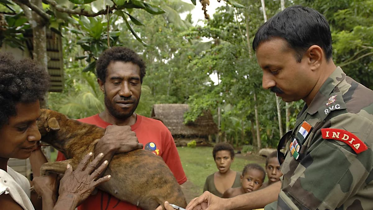 MADANG, Papua New Guinea (Aug. 10, 2007) - Lt. Col. Raveesh Chhajed, a veterinarian from the Indian Army, gives a rabies vaccination to a family dog during a veterinarian civil-assistance program in s